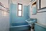 Full bath with tile walls and  shower combination