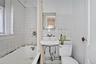 Full bathroom featuring tile walls, decorative backsplash, and shower / tub combo with curtain