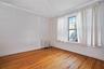 Empty room featuring radiator, crown molding, and light wood finished floors