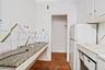Kitchen with freestanding refrigerator, dark wood-style floors, and white cabinets