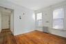 Spare room with radiator heating unit and hardwood / wood-style floors