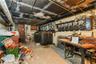 Unfinished below grade area featuring heating fuel and a workshop area