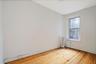 Spare room featuring radiator and light wood-style flooring