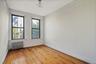 Spare room with radiator heating unit and light wood-style floors
