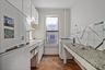 Kitchen featuring white appliances, dark wood-style floors, white cabinetry, and a textured ceiling