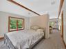 Bedroom featuring light carpet, multiple windows, and recessed lighting
