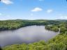 Aerial view of a heavily wooded area and a large body of water