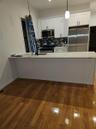 Kitchen with dark wood finished floors, a sink, decorative backsplash, appliances with stainless steel finishes, and white cabinetry