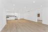 Unfurnished living room featuring light wood-style flooring, an AC wall unit, and recessed lighting