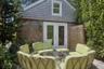 View of pool house with bathroom featuring french doors and outdoor lounge area
