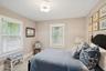 Bedroom with carpet floors and wallpapered walls