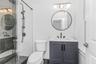 Full bathroom with vanity and a stall shower