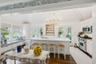 Kitchen featuring appliances with stainless steel finishes, plenty of natural light, dark wood finished floors, a breakfast bar area, and wooden ceili