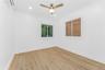 Unfurnished room featuring a wall unit AC, ceiling fan, light wood-style floors, and recessed lighting