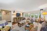 Living room with ornamental molding and wood finished floors