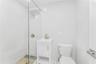 Bathroom with tile walls, a tile shower, and vanity