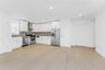 Kitchen with appliances with stainless steel finishes, wall chimney range hood, light wood-type flooring, backsplash, and recessed lighting