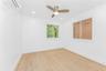 Unfurnished room with a wall mounted air conditioner, light wood-style flooring, a ceiling fan, and recessed lighting