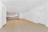 Unfurnished living room featuring light wood-style flooring, recessed lighting, and an AC wall unit