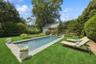 View of swimming pool featuring a yard and an outdoor structure