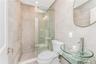Bathroom with tile walls and a shower stall