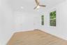 Empty room with light wood-style flooring, ceiling fan, and recessed lighting