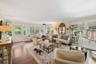 Living room featuring wood finished floors and crown molding