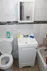 Full bathroom featuring tile walls, vanity, tile patterned flooring, a bathtub, and tasteful backsplash