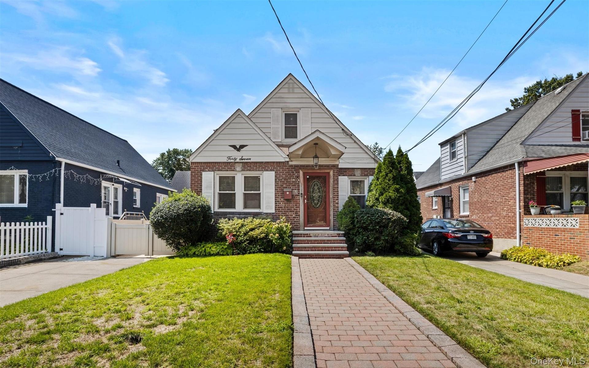 Bungalow-style house featuring brick siding and a gate