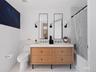 Full bath with shower / bathtub combination with curtain and a sink