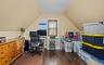 Home office with dark wood-type flooring and vaulted ceiling