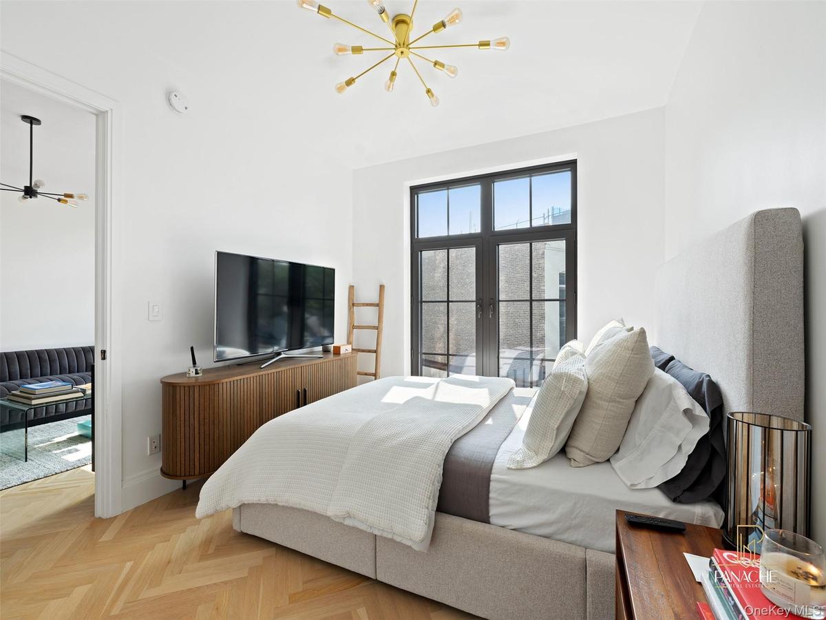 Bedroom featuring a chandelier and baseboards