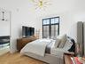 Bedroom featuring a chandelier and baseboards