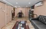 Living room with recessed lighting, a wall unit AC, and light tile patterned floors