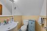 Half bathroom with vanity and vaulted ceiling
