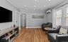 Living area with arched walkways, crown molding, wood finished floors, and recessed lighting
