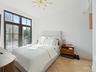Bedroom featuring access to exterior and a chandelier