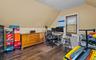 Home office featuring vaulted ceiling and dark wood finished floors