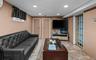 Living area featuring recessed lighting and an AC wall unit