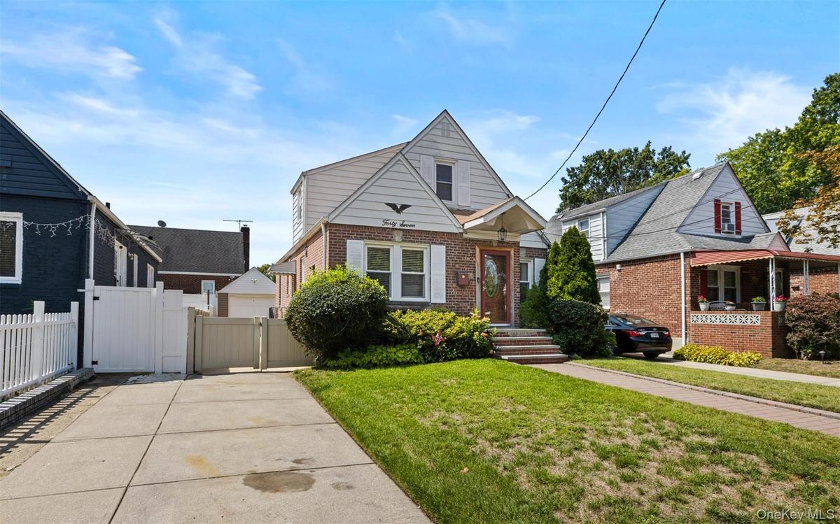 Bungalow with brick siding and a gate