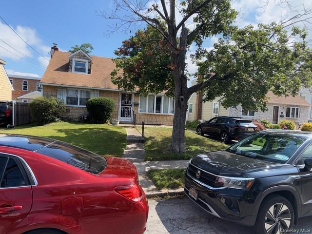 View of front of property featuring a chimney and a front yard