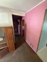 Hallway with crown molding and carpet floors