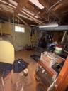 Below grade area with oil tank and water heater