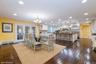 Dining room with dark wood-style flooring, recessed lighting, a chandelier, a baseboard radiator, and french doors