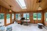 Home office featuring wooden walls, vaulted ceiling, wooden ceiling, light tile patterned floors, and baseboard heating