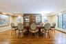 Dining area featuring wood finished floors, crown molding, and wallpapered walls