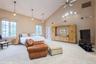 Bedroom featuring high vaulted ceiling, carpet floors, access to exterior, and a ceiling fan