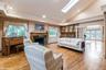 Living area with french doors, high vaulted ceiling, light wood-style floors, recessed lighting, and a fireplace