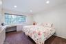 Bedroom with dark carpet, recessed lighting, a baseboard radiator, and an office area