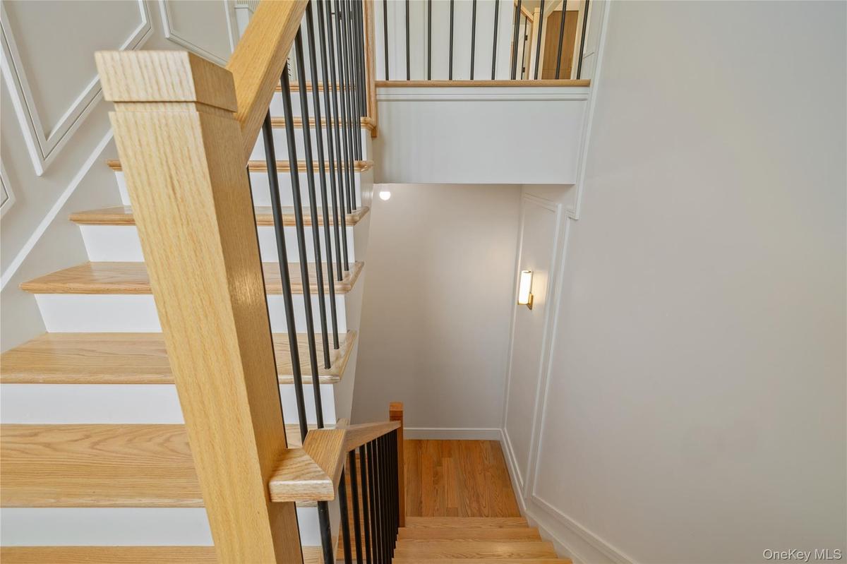 Stairway featuring wood finished floors and baseboards